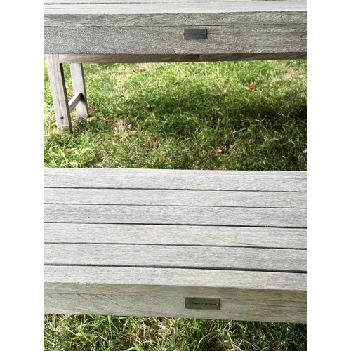 155 - PANAMA GARDEN BENCHES AND TABLE, a pair, rectangular well weathered slatted teak together with match... 