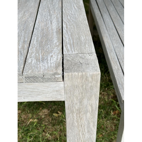 155 - PANAMA GARDEN BENCHES AND TABLE, a pair, rectangular well weathered slatted teak together with match... 