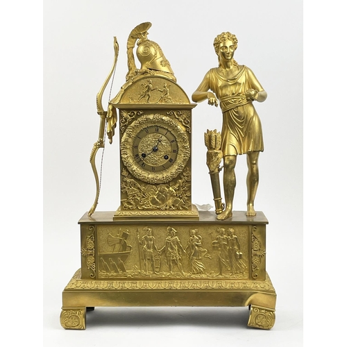 MANTLE CLOCK, 19th century French Empire gilt bronze, with Diana the huntress figure holding an apple with her bow helmet sword cloak and quiver resting above a Classical frieze, 51cm H x 36cm x 12cm.