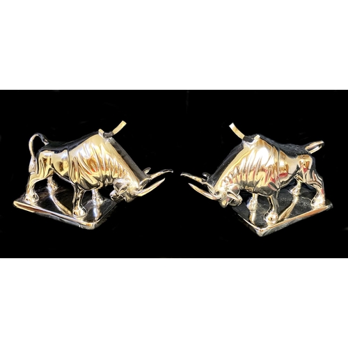 383 - WINE BOTTLE HOLDERS, a pair, in the form of bulls, 26cm H x 46cm x 25cm. (2)