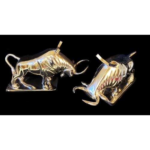 383 - WINE BOTTLE HOLDERS, a pair, in the form of bulls, 26cm H x 46cm x 25cm. (2)