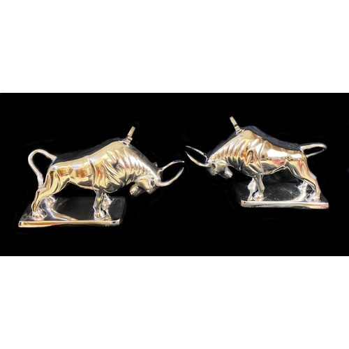 383 - WINE BOTTLE HOLDERS, a pair, in the form of bulls, 26cm H x 46cm x 25cm. (2)