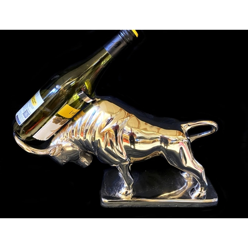 383 - WINE BOTTLE HOLDERS, a pair, in the form of bulls, 26cm H x 46cm x 25cm. (2)