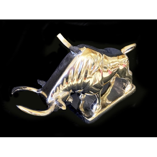 383 - WINE BOTTLE HOLDERS, a pair, in the form of bulls, 26cm H x 46cm x 25cm. (2)