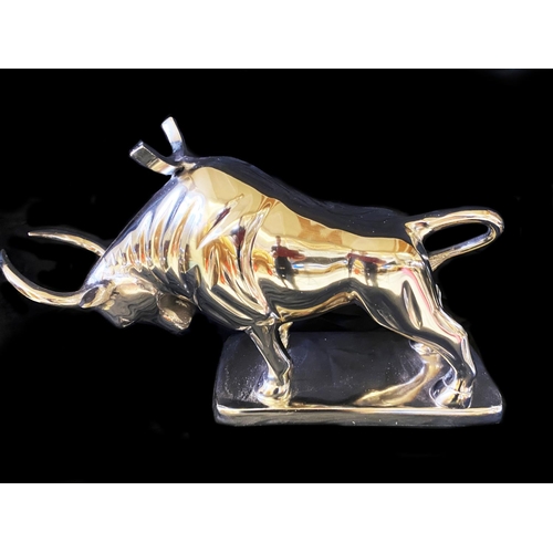 383 - WINE BOTTLE HOLDERS, a pair, in the form of bulls, 26cm H x 46cm x 25cm. (2)