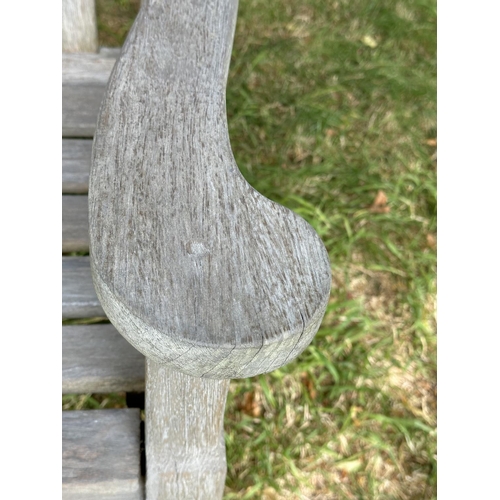 157 - GARDEN BENCH BY BRIDGMAN & CO, well weathered teak with shaped, incised top rail, slatted seat and s... 