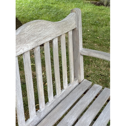 157 - GARDEN BENCH BY BRIDGMAN & CO, well weathered teak with shaped, incised top rail, slatted seat and s... 