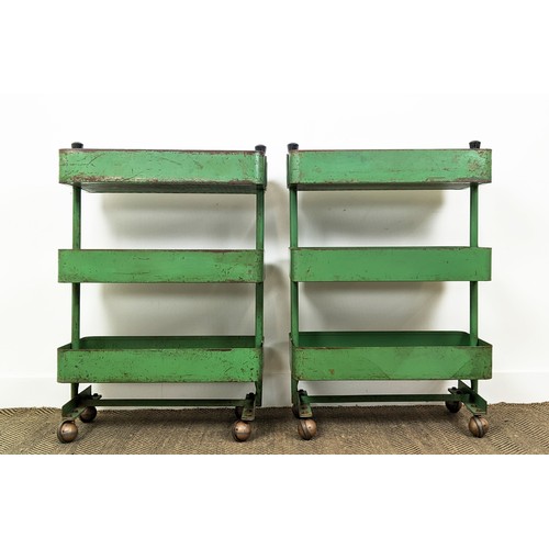 242 - WORKSHOP TROLLEYS, a pair, mid 20th century original green painted metal each with three tiers (on c... 