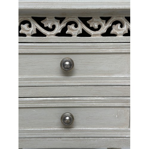 148 - BEDSIDE CHESTS, a pair, French style grey painted each with two drawers and pierced frieze, 40cm x 3... 