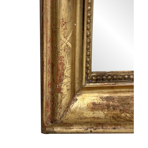 119 - WALL MIRROR, 19th century French giltwood and gesso with arched rectangular beaded and incised frame... 