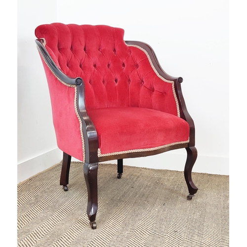 397 - ARMCHAIR, Edwardian with a mahogany showframe and button back red velvet upholstery on steel castors... 