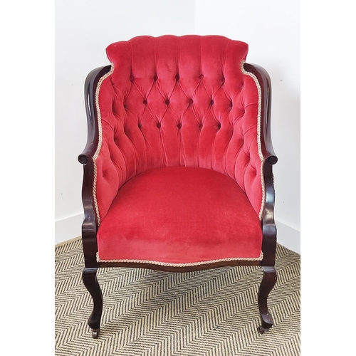 397 - ARMCHAIR, Edwardian with a mahogany showframe and button back red velvet upholstery on steel castors... 