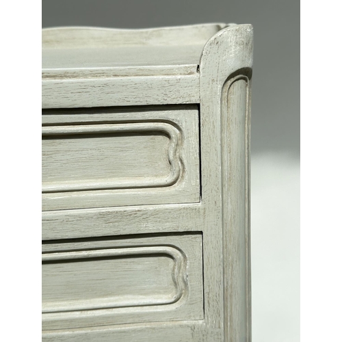 131 - BEDSIDE CHESTS, a pair, French traditionally grey painted each with three drawers, 36cm W x 67cm H x... 