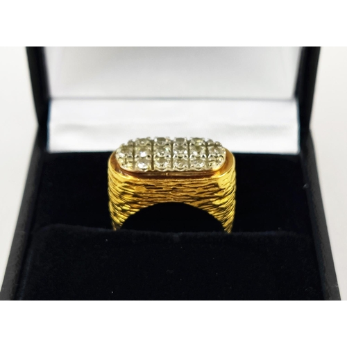 22 - A YELLOW METAL AND DIAMOND SET DRESS RING, set with three rows of round brilliant cut diamonds, rust... 