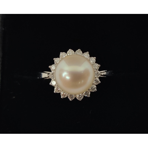 26 - A 9CT WHITE GOLD CULTURED PEARL AND DIAMOND RING, the single pearl surrounded by a halo of 18 round ... 