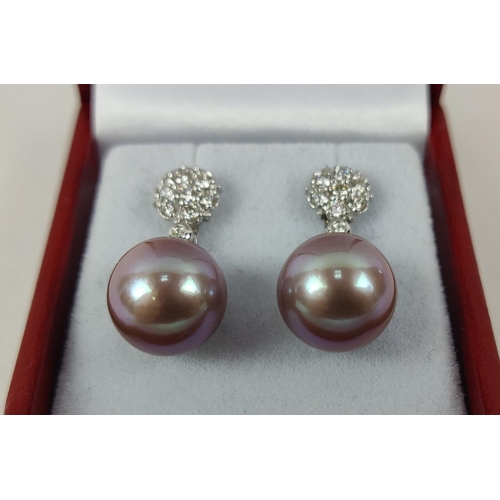 27 - A PAIR OF 18CT WHITE GOLD PEARL PENDANT EARRINGS, the studs set with round brilliant cut diamonds, t... 