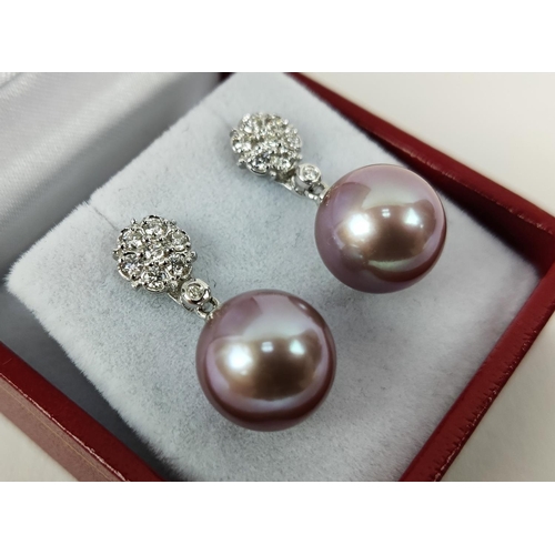 27 - A PAIR OF 18CT WHITE GOLD PEARL PENDANT EARRINGS, the studs set with round brilliant cut diamonds, t... 