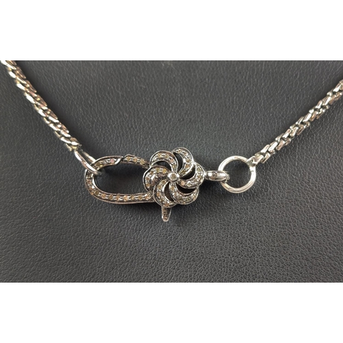 29 - A WHITE METAL CHAIN WITH A DECORATIVE DIAMOND ENCRUSTED CLASP, the clasp with rough cut diamonds to ... 