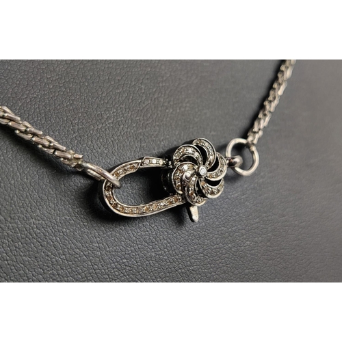 29 - A WHITE METAL CHAIN WITH A DECORATIVE DIAMOND ENCRUSTED CLASP, the clasp with rough cut diamonds to ... 