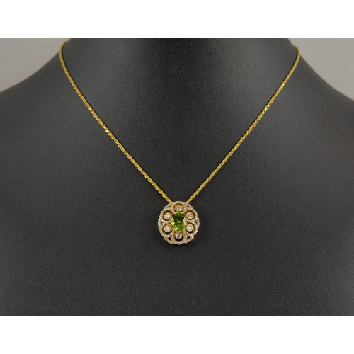 35 - A 14CT GOLD PERIDOT AND DIAMOND PENDANT, the central oval cut peridot of approximately 1.80 carats, ... 