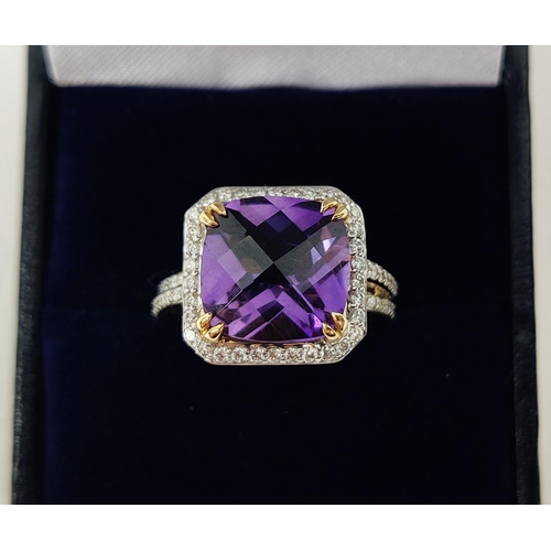 39 - AN 18CT GOLD AMETHYST AND DIAMOND DRESS RING, the central cushion cut amethyst surrounded by round b... 