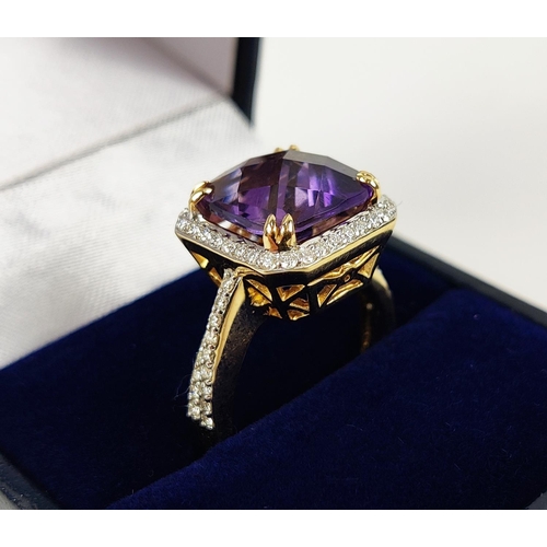 39 - AN 18CT GOLD AMETHYST AND DIAMOND DRESS RING, the central cushion cut amethyst surrounded by round b... 