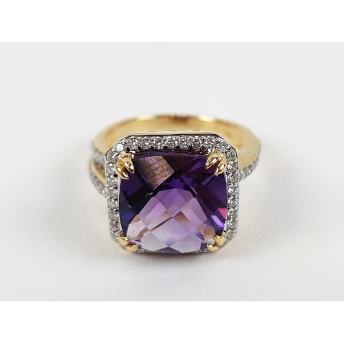 39 - AN 18CT GOLD AMETHYST AND DIAMOND DRESS RING, the central cushion cut amethyst surrounded by round b... 