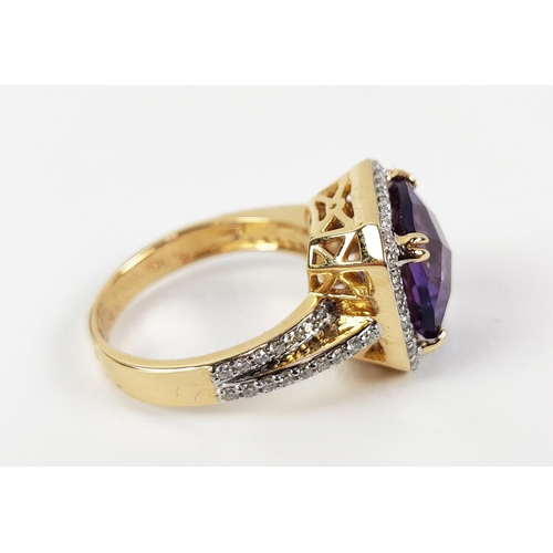 39 - AN 18CT GOLD AMETHYST AND DIAMOND DRESS RING, the central cushion cut amethyst surrounded by round b... 