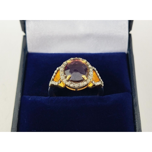 40 - A GEORGIAN STYLE RHODOLITE GARNET AND DIAMOND SET DRESS RING, gilt metal shank, the rose cut garnet ... 