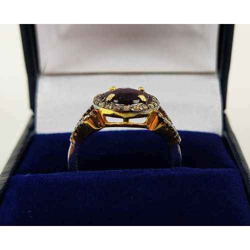 40 - A GEORGIAN STYLE RHODOLITE GARNET AND DIAMOND SET DRESS RING, gilt metal shank, the rose cut garnet ... 