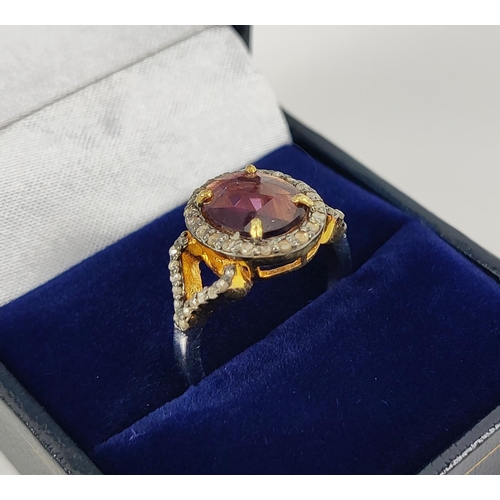 40 - A GEORGIAN STYLE RHODOLITE GARNET AND DIAMOND SET DRESS RING, gilt metal shank, the rose cut garnet ... 