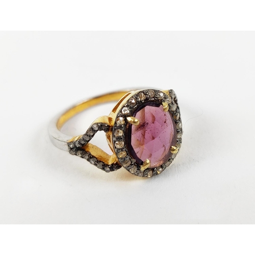 40 - A GEORGIAN STYLE RHODOLITE GARNET AND DIAMOND SET DRESS RING, gilt metal shank, the rose cut garnet ... 