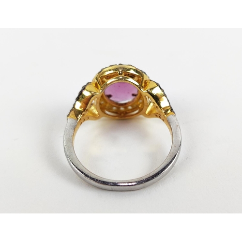 40 - A GEORGIAN STYLE RHODOLITE GARNET AND DIAMOND SET DRESS RING, gilt metal shank, the rose cut garnet ... 