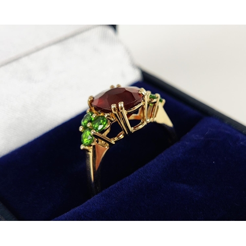 41 - A SPESSARTINE GARNET AND GREEN STONE DRESS RING, 9ct gold shank, the central mixed cut stone surroun... 