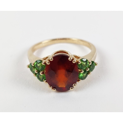 41 - A SPESSARTINE GARNET AND GREEN STONE DRESS RING, 9ct gold shank, the central mixed cut stone surroun... 