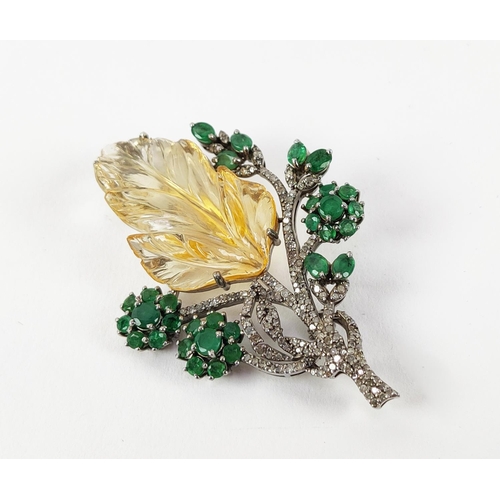 43 - A TREE OF LIFE BROOCH, the central foliage cut citrine, surrounded by round mixed cut emeralds, whit... 