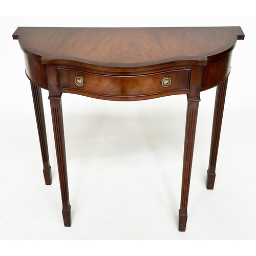 140 - HALL TABLE, George III design, flame mahogany of serpentine outline with frieze drawer and tapering ... 