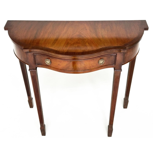 140 - HALL TABLE, George III design, flame mahogany of serpentine outline with frieze drawer and tapering ... 