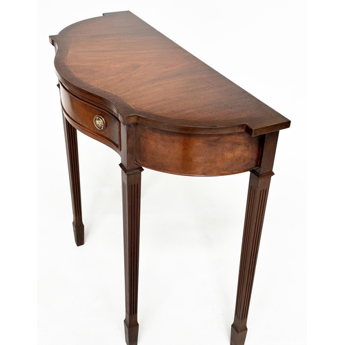 140 - HALL TABLE, George III design, flame mahogany of serpentine outline with frieze drawer and tapering ... 