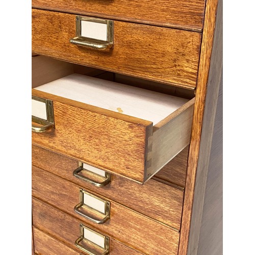 99 - FILING CHEST, mid 20th century oak with eighteen drawers and brass labels/handles, stamped 'ER' Gove... 