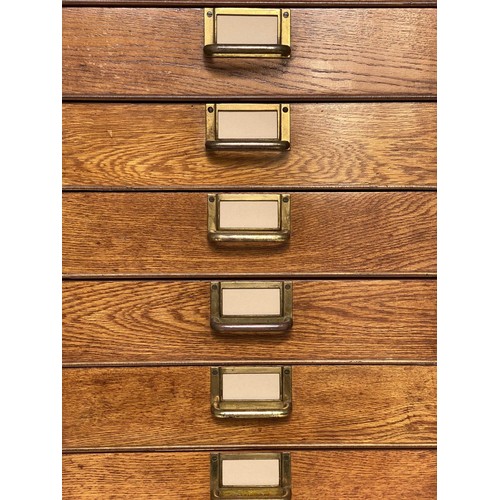 99 - FILING CHEST, mid 20th century oak with eighteen drawers and brass labels/handles, stamped 'ER' Gove... 