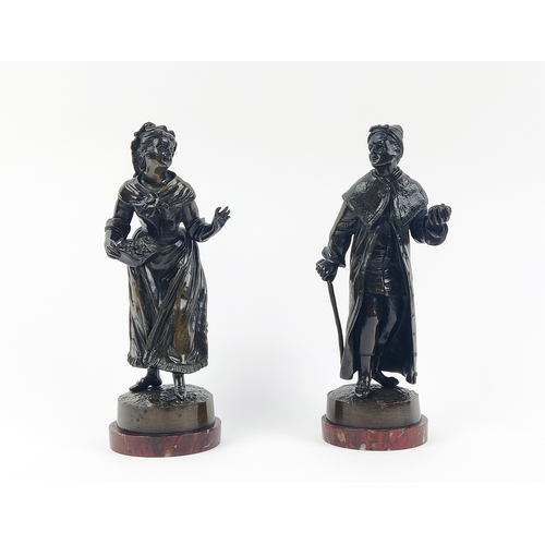 22 - BRONZE FIGURES, two, 19th century continental, one of a caped gentleman and a lady with a basket of ... 