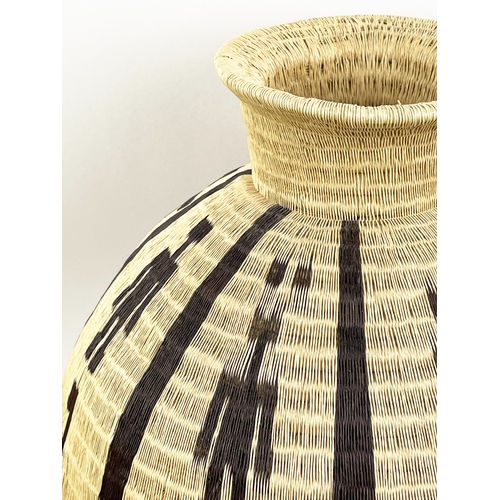 25 - COLOMBIAN WERREGUE WOVEN PALM VASE,  55cm H.