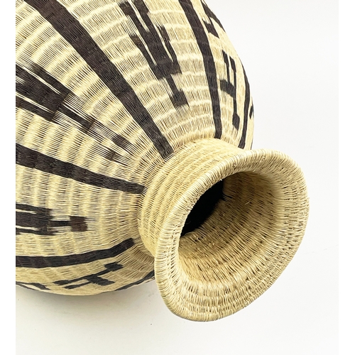 25 - COLOMBIAN WERREGUE WOVEN PALM VASE,  55cm H.