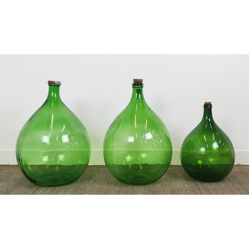 419 - DEMI JOHN BOTTLES, a set of three , green glass, largest 69cm H x 44cm W. (3)