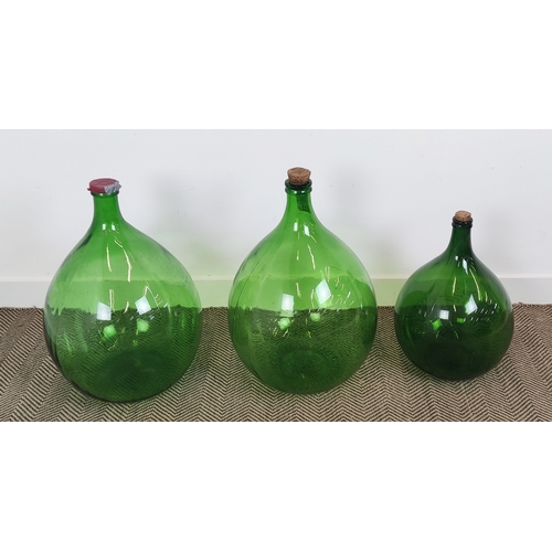 419 - DEMI JOHN BOTTLES, a set of three , green glass, largest 69cm H x 44cm W. (3)