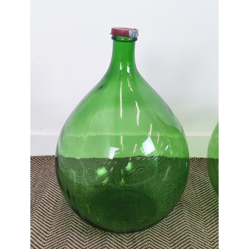 419 - DEMI JOHN BOTTLES, a set of three , green glass, largest 69cm H x 44cm W. (3)