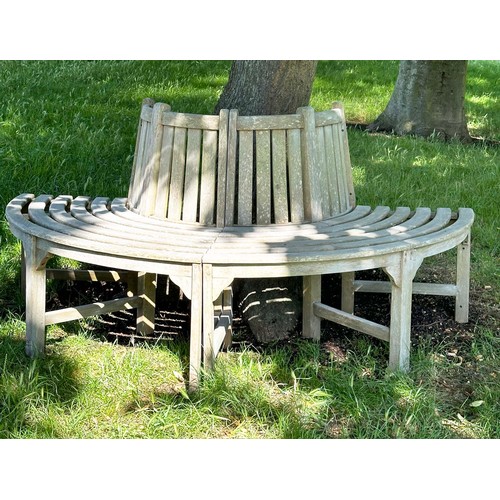 139 - GARDEN TREE BENCH, nicely weathered teak forming half round (two quadrants) of slatted form with upr... 