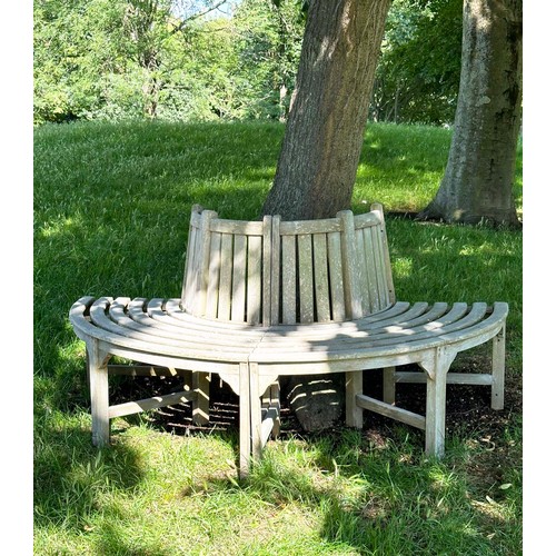 139 - GARDEN TREE BENCH, nicely weathered teak forming half round (two quadrants) of slatted form with upr... 