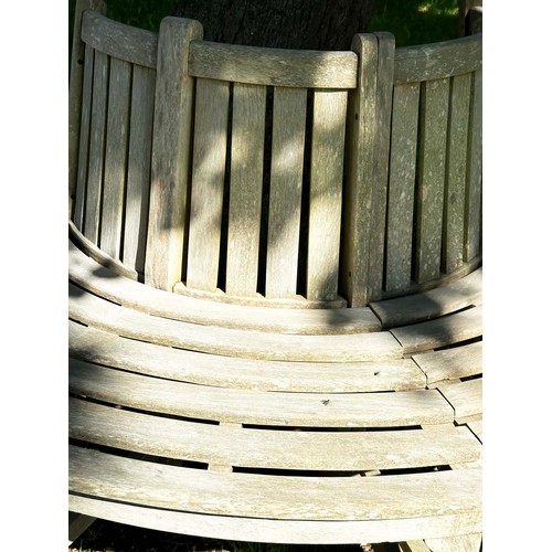 139 - GARDEN TREE BENCH, nicely weathered teak forming half round (two quadrants) of slatted form with upr... 